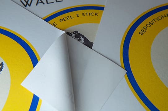 Photo of a woman installing peel and stick wallpaper